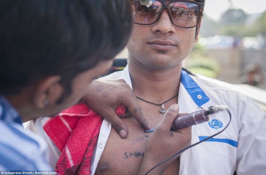 indian man getting tattoo